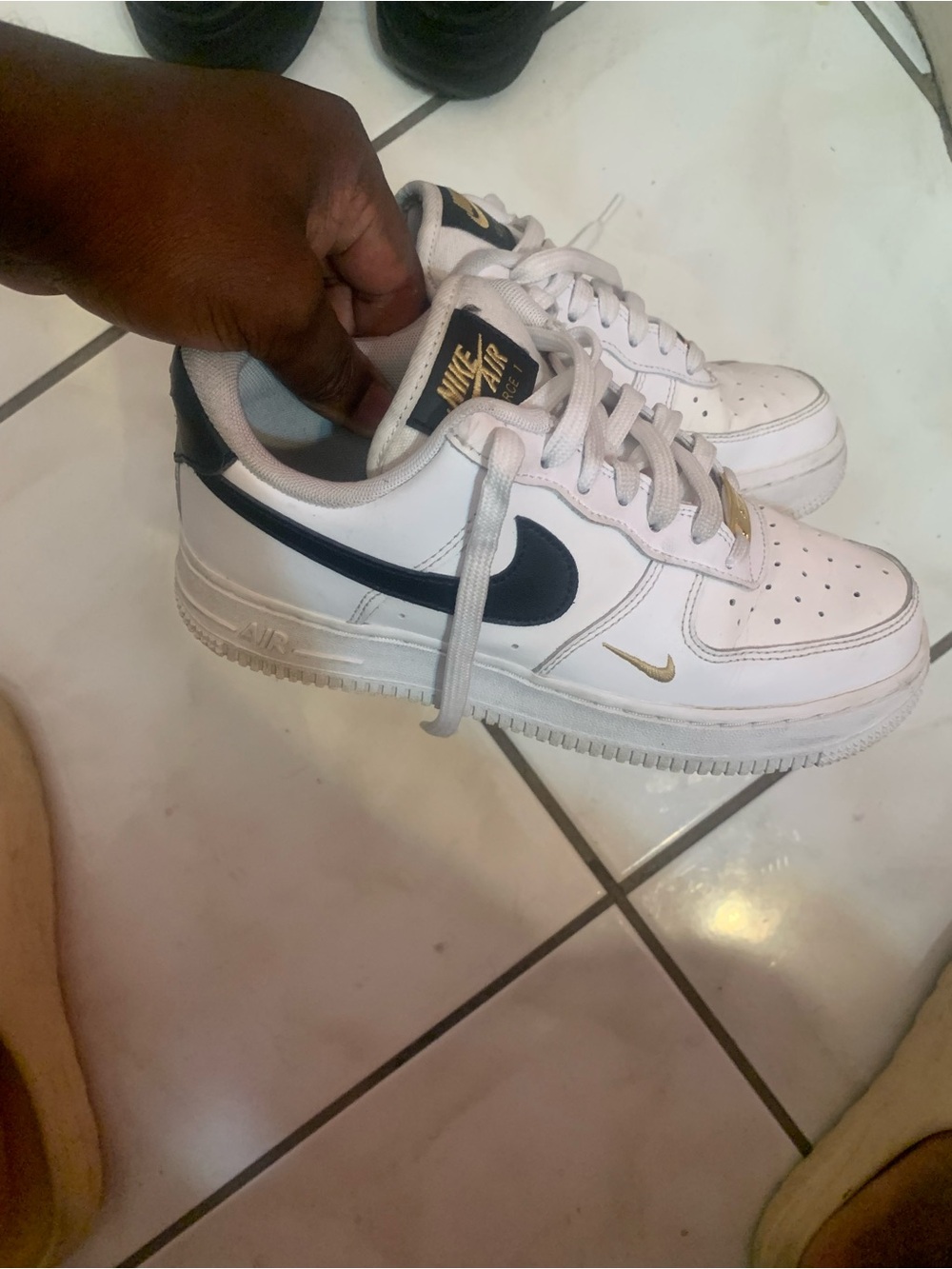 Nike White Kids Sneakers with Black Swoosh and Gold Accents